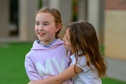 Two girls smiling. Links to Gifts of Life Insurance