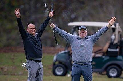 Two men cheering at a golf course. Link to Life Stage Gift Planner Under Age 60 Situations.