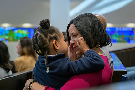 A mother holding her daughter. Links to Closely Held Business Stock