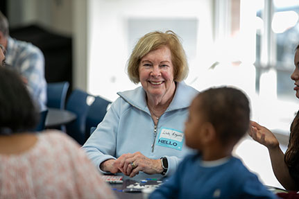 A woman smiling at the camera. Links to Gifts of Appreciated Securities