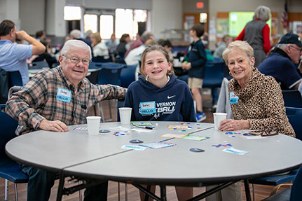 Grandparents smiling with their granddaughter. Link to Life Stage Gift Planner Over Age 70 Situations.
