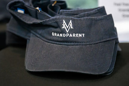 A visor with the MT logo and grandparent printed on it. Links to Gifts of Real Estate