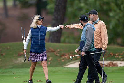 A woman doing a fist bump with a man. Links to Tangible Personal Property